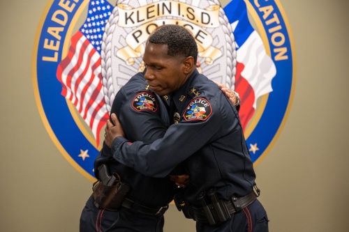 Outgoing longtime Klein ISD Police Chief David Kimberly embraces his successor, Marlon Runnels, during a pinning ceremony June 2. (Courtesy Klein ISD)