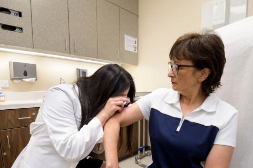 Dr. Kroger inspects Cynthia’s skin during a recent visit.