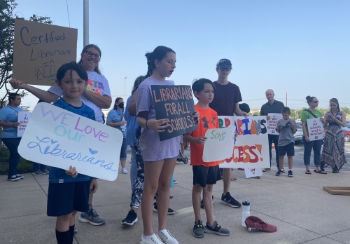Several dozen PfISD students and advocates to keep librarians at all Pflugerville ISD campuses held a protest rally before a June 16 board of trustees meeting. (Brian Rash/Community Impact Newspaper)