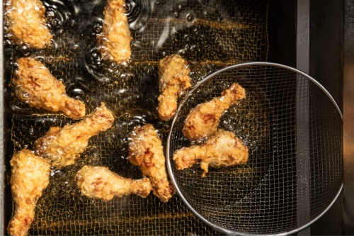 chicken drumsticks in frying oil