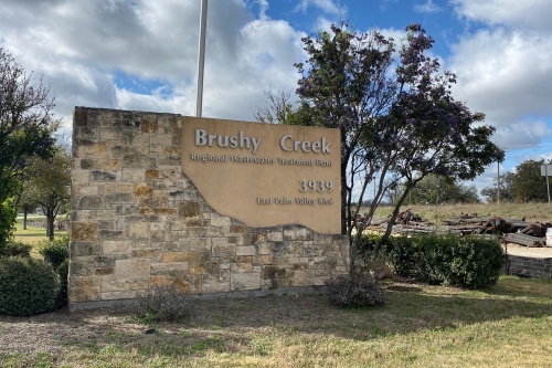 Contractor error is believed to be the cause of an unauthorized discharge of raw sewage into Brushy Creek after overflowing from a nearby manhole. (Brooke Sjoberg/Community Impact Newspaper)