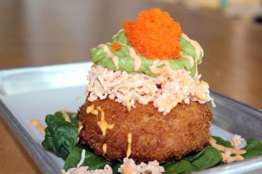 The sushi donut ($8.95) is a deep-fried sticky white rice doughnut with crab mix, avocado mash, spicy mayo and masago. (Karen Chaney/Community Impact Newspaper)