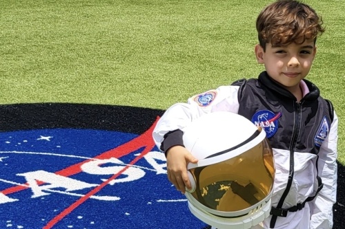 Luca Esparza, an incoming second-grader at Stone Oak Elementary School, went with his family to Cape Canaveral, Florida, to see the SpaceX Falcon 9 rocket launch on May 25. Falcon 9 contained 59 small payloads, including a methane emissions-monitoring satellite nicknamed “Luca.” (Courtesy Angel Esparza/North East ISD)