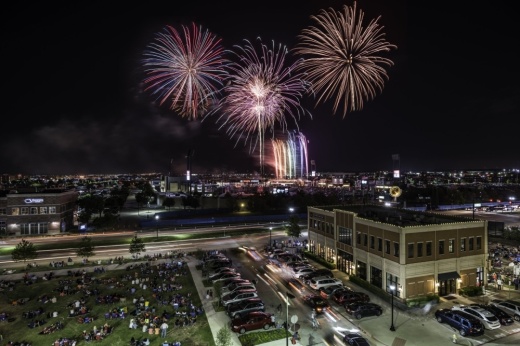 Fireworks above buildings at Frisco Freedom Fest