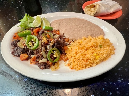 Barbacoa a la Mexicana ($11.99) comes with grilled barbacoa sauteed with onions, jalapenos and tomatoes. It is served with rice, beans and homemade flour tortillas. (Courtesy Elizabeth Moreno)