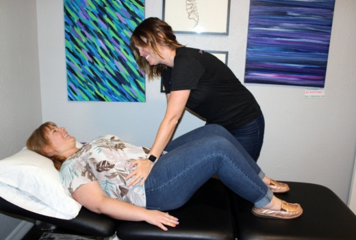 Physical therapist Stefanie Long demonstrates treatment on patient model Natalie Moore. (Karen Chaney/Community Impact Newspaper)