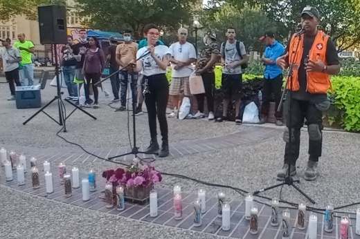 Venezuela native Jessy Amaya addresses the crowd at a migrants’ rights rally June 30 at Travis Park in San Antonio. At left is local community organizer Monica Sosa. Amaya and Sosa were among several speakers at the rally where attendees paid tribute to 53 migrants who died after being left to suffocate in a semitrailer found abandoned June 27 in southwest San Antonio. Candles were lit in memory of the deceased migrants. (Edmond Ortiz/Community Impact Newspaper)