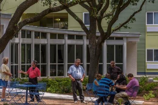 Residents gather in a public space at an affordable housing community run by the nonprofit New Hope Housing in Houston. New Hope has ambitions to build between two and three new communities per year over the next few years, but rising costs of construction materials and land have made it hard to builders to deliver and maintain affordable units. (Courtesy New Hope Housing)