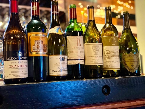 bottles of wine lined up on shelf