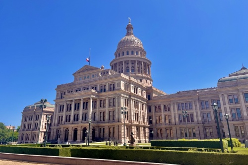 Photo of the Texas State Capitol on a sunny day, from a downward angle.