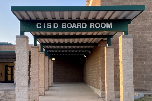 walkway with sign reading "CISD Board Room"