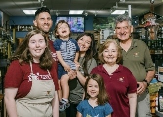 Wild Birds Unlimited owners Manuel and Anna Peña (right), with their daughter, Amanda Peña Bustillos (center), her husband, Hector Bustillos, their children Camila and Joaquin, and employee Kenzie Reitler (left). (Courtesy Wild Birds Unlimited/Claire Mulkey)