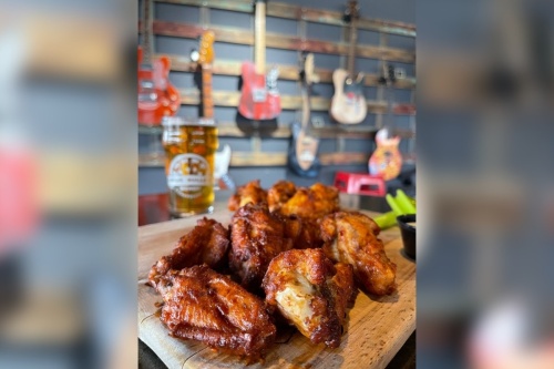 plate of wings with beer and guitars