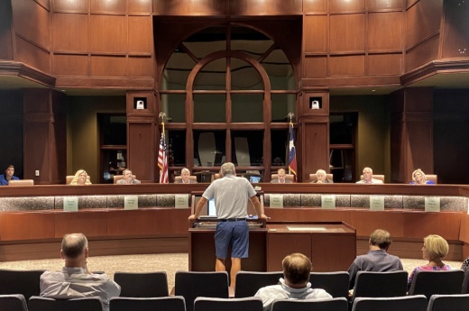 man stands before city council