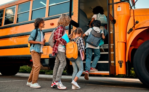 School children entering a school bus. 