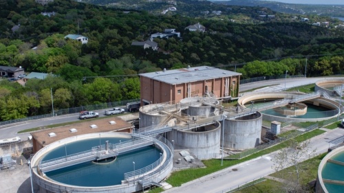 A giant water management plant which looks like a building with two vats of water at either side 