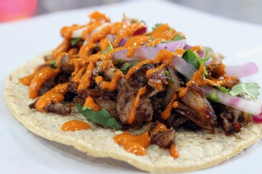 The El Santo ($3.99) has grilled pork with radish, cilantro, red onions and special homemade guajillo cream sauce. (Karen Chaney/Community Impact Newspaper)
