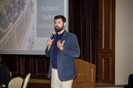 man holds microphone while giving speech