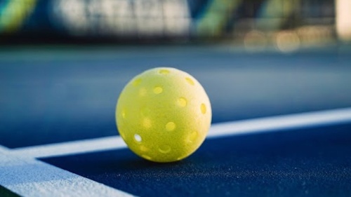 The game of pickleball uses a perforated ball similar to a Wiffle ball. (Courtesy Adobe Stock)