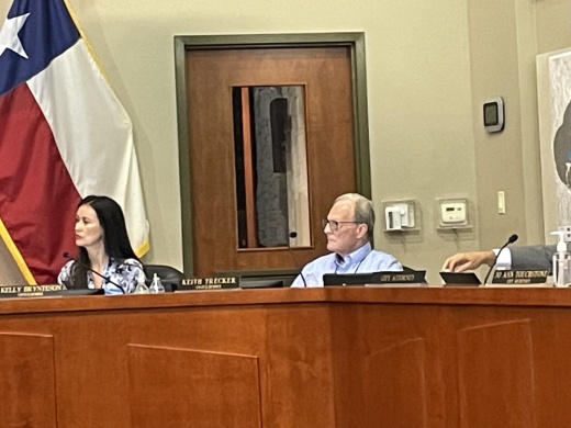 A man and a woman sitting on a dais.