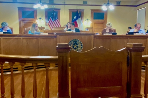 Five people sitting behind a dias