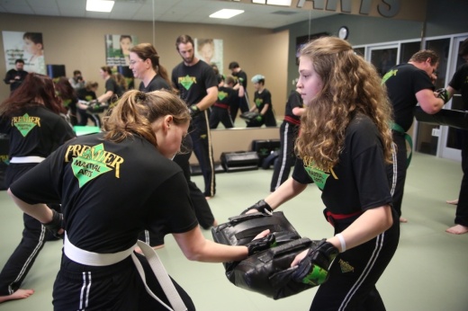 two women practicing martial arts with gloves