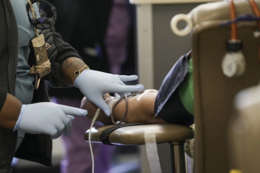 person giving blood in chair