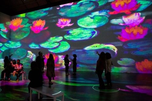 Guests walk through a Claude Monet exhibit at Lighthouse Immersive. (Courtesy Patrick Hodgon)