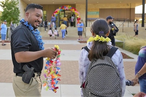 Some of the Dallas ISD Police Department's nearly 200 officers help welcome students back on the first day at one of the district's 228 campuses. (Courtesy Dallas ISD)