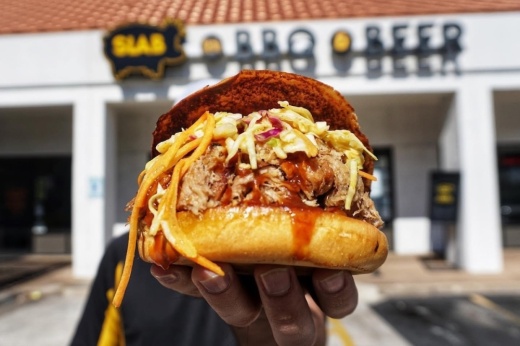 The Notorious P.I.G. sandwich has pulled pork, mustard coleslaw and backyard red barbecue sauce. (Courtesy Slab BBQ & Beer)