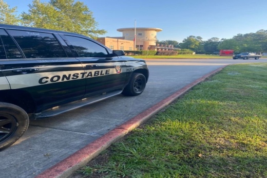 A black SUV with a yellow band across its door and black text saying "Constable" superimposed on the band