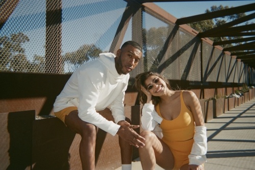 two people posing on a bridge
