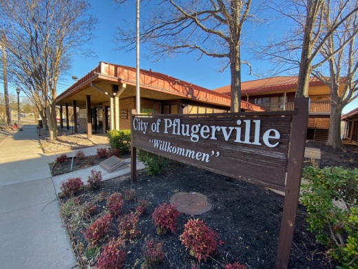 Photo of a sign reading "City of Pflugerville" and "Willkommen"