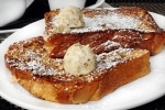 French Toast served at Fork & Spoon is made with traditional homemade Challah bread, topped with powdered sugar and honey pecan butter. (Courtesy Fork & Spoon/Community Impact Newspaper)