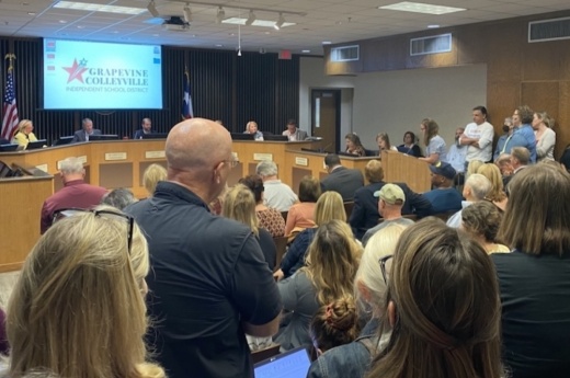 school board meeting filled with people 