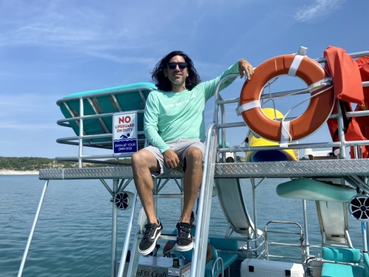 man posing on top of boat