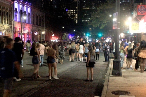 Photo of a crowded Sixth Street at night