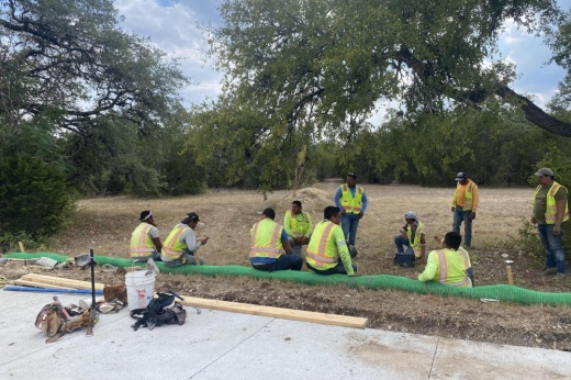 A construction crew resting in 104-degree temperatures while working on a project along Slaughter Lane. (Darcy Sprague/Community Impact Newspaper)