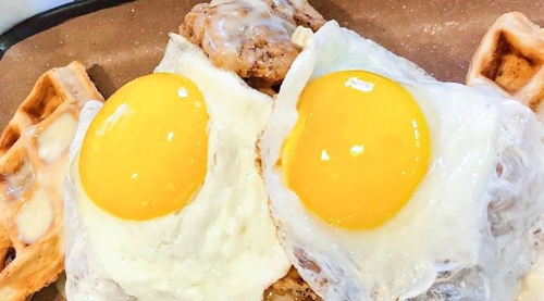 Texas Bean and Brew House's Chicken and Waffles comes with eggs on top. (Courtesy Texas Bean and Brew House)