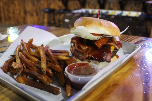 The Bourbon Bacon Burger ($13.99) is a half-pound patty with two slices of cheddar cheese, thick-cut bacon, fried onion strings, lettuce, tomato and bourbon sauce on a sweet sourdough bun. (Peyton MacKenzie/Community Impact Newspaper)