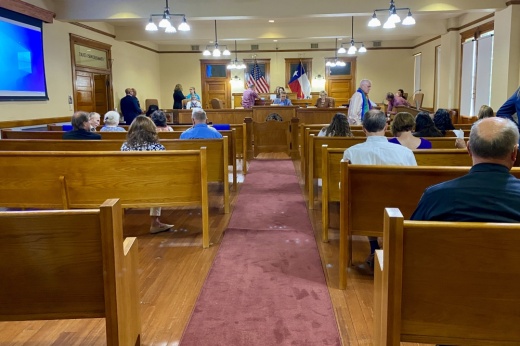 People sitting on benches inside a court
