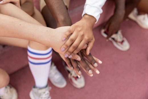 group of people stacking their hands