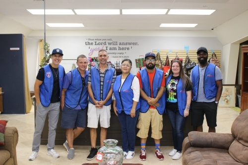 Owner Brandon Langer (far left) opened the nonprofit thrift store in August 2021, which supports Crossbar Academy in Tomball financially. He is pictured alongside his staff at the Tomball store. (Peyton MacKenzie/Community Impact Newspaper)