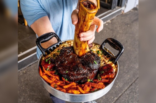 Red Flame Steak & Grill is headed to Katy in November. Its menu features a variety of cuts, including one the restaurant calls Thor's Hammer, a slow-smoked beef shin served with macaroni and cheese and french fries. (Courtesy Red Flame Steak & Grill)