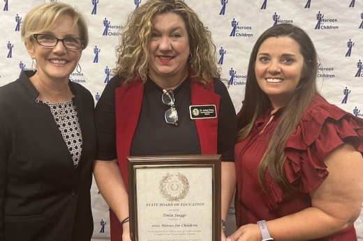 Tonia Jaeggi (right) received a plaque commemorating her service to the district and her title of Hero for Children. (Courtesy Cy-Fair ISD)