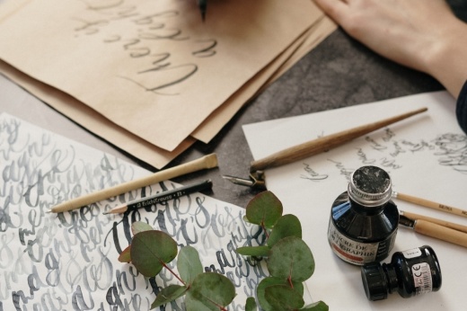 close up of person drawing calligraphy art