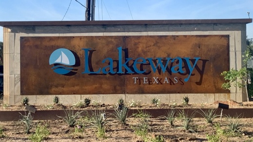 Sign that says Lakeway in a field. 