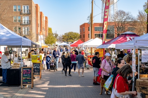 People walking around vendors booths at the McKinney Farmers Market.