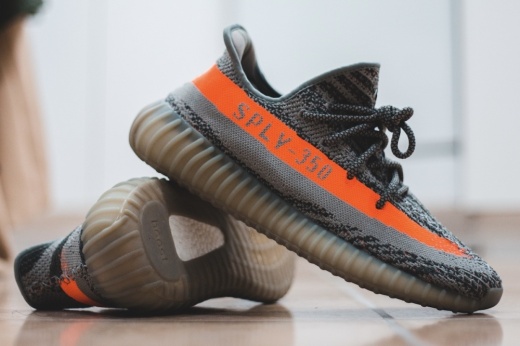 Yeezy sneakers with orange stripe on side