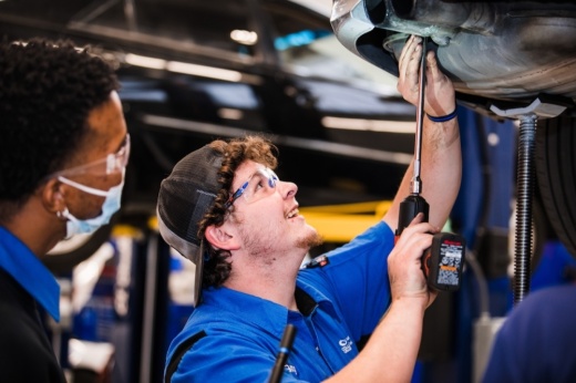 Students work on cars in the automotive bay of the Collin College Technical Campus in Allen. (Sara Carpenter/Collin College)